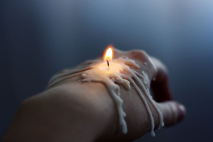 A Burning Candle In His Hand