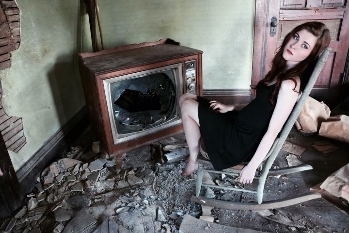 Girl Sitting In The Broken Old Tv