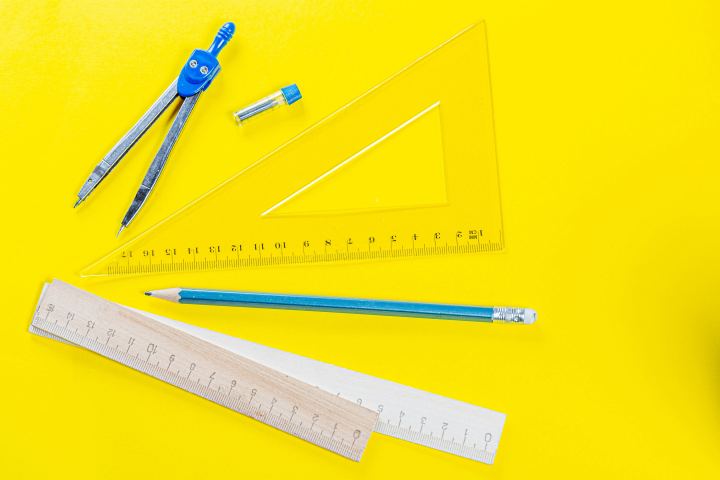 Rulers Compasses And Pencil On Yellow Background