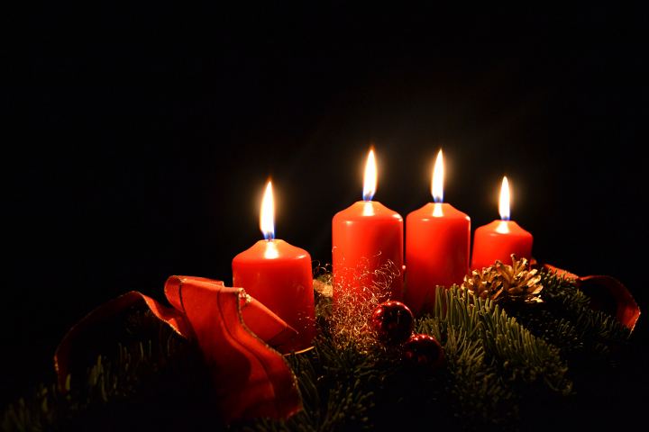 Three Burning Red Candles With Fir Branch On Black Background