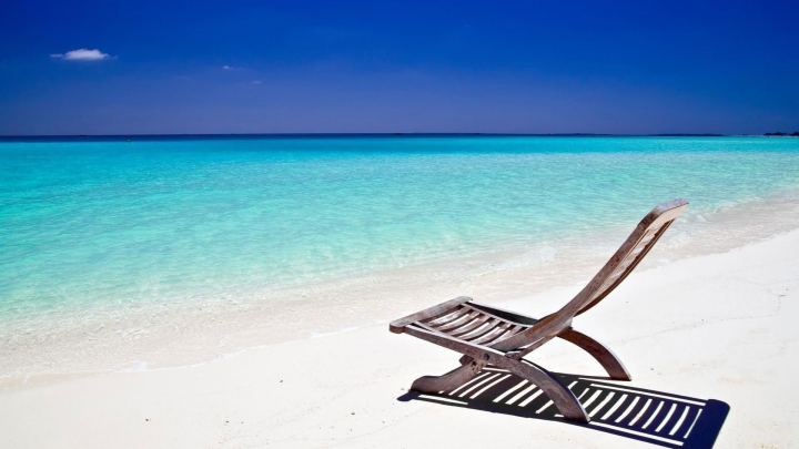 Wooden Beach Chair On Sand During Sunny Time